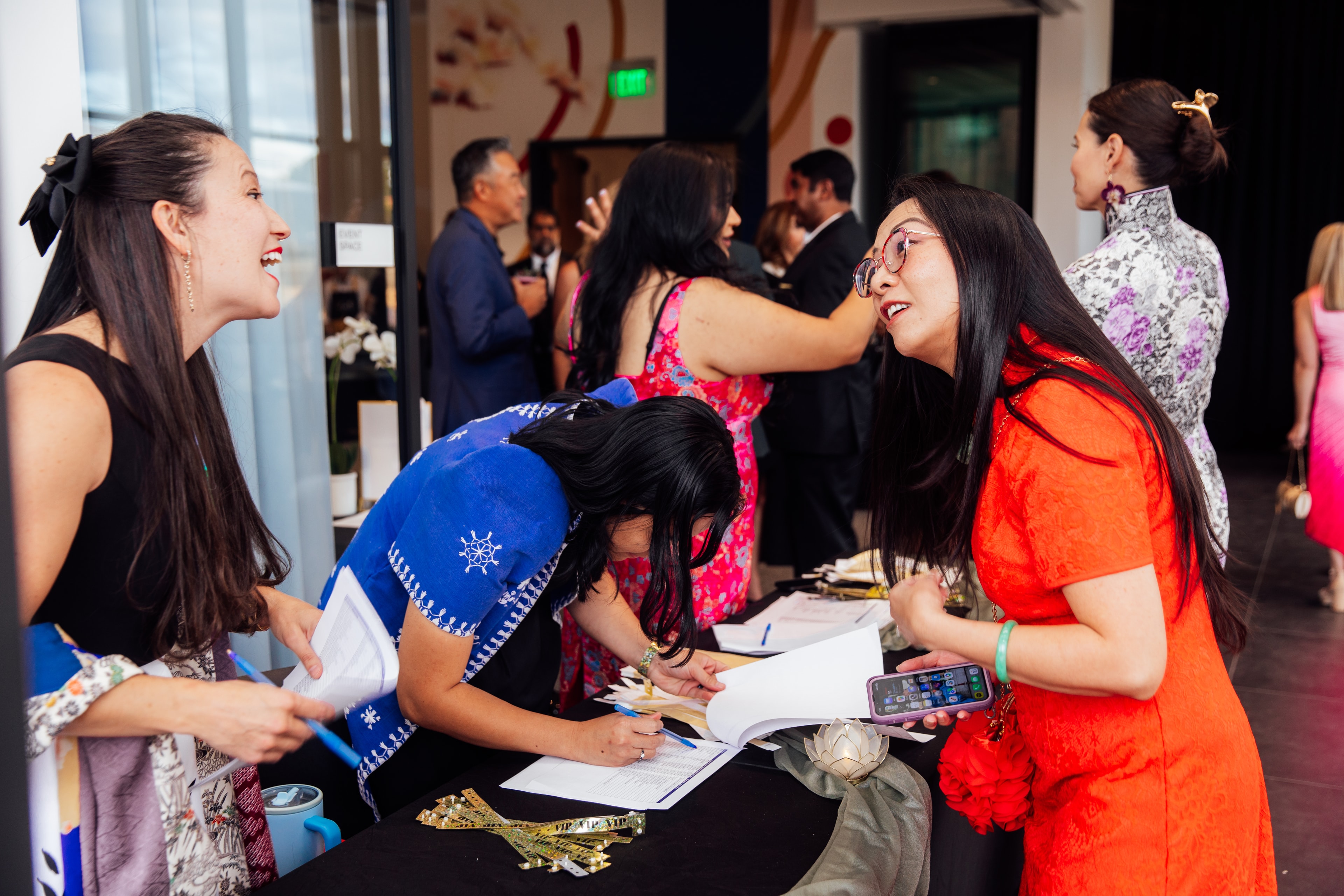 Guests laughing and connecting at the Jade Circle Gala
